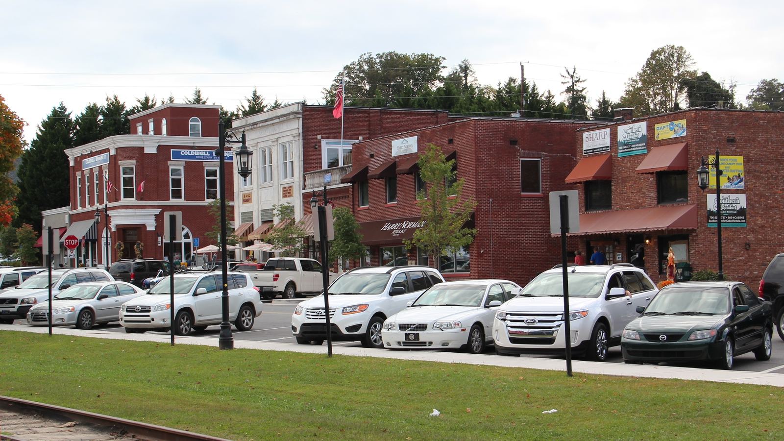 Red-brick storefronts and parked cars on a street in downtown Blue Ridge, Georgia