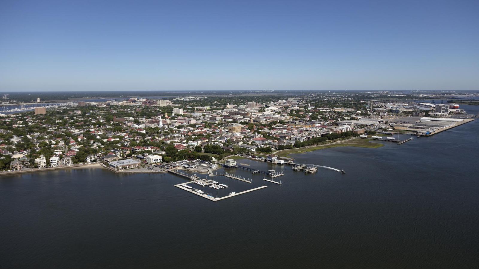 Aerial view of the Charleston peninsula and its marinas on the harbor under a clear sky